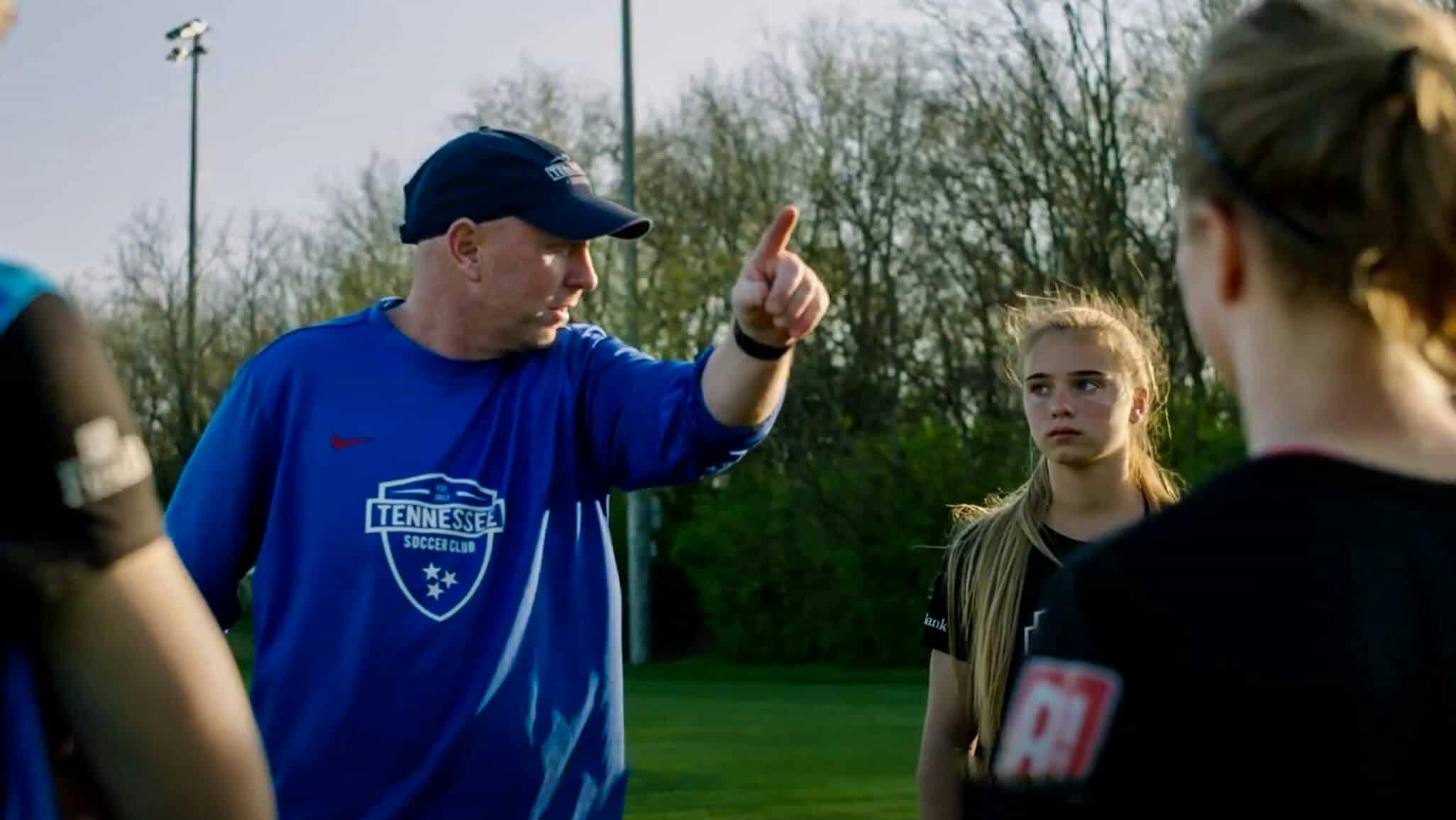 Coach of Tennessee leading a training session, giving instructions to their players.